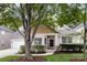 Charming exterior view of a single-Gathering home with a well-manicured lawn and inviting front porch at 1040 Stonedown Ln, Matthews, NC 28104