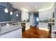 Charming kitchen with gray backsplash, granite countertops, stainless steel appliances, and hardwood floors at 1040 Stonedown Ln, Matthews, NC 28104