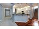 Eat-in kitchen with bar-style seating, gray subway tile backsplash, stainless steel appliances, and hardwood floors at 1040 Stonedown Ln, Matthews, NC 28104