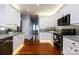 Lovely kitchen with white cabinetry, stainless appliances, a gray subway tile backsplash, and hardwood flooring at 1040 Stonedown Ln, Matthews, NC 28104