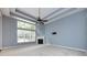Bright living room with fireplace, tray ceiling, large windows, and blue walls at 1040 Stonedown Ln, Matthews, NC 28104