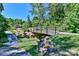Scenic walking path featuring a charming wooden bridge over a creek, surrounded by lush greenery at 1040 Stonedown Ln, Matthews, NC 28104