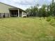 Spacious backyard featuring lush green grass, a trampoline and an elegant black fence at 10417 Bluejack Oak Ct, Huntersville, NC 28078