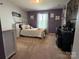 This bedroom boasts plush carpet, and decor at 10417 Bluejack Oak Ct, Huntersville, NC 28078