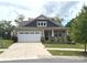 Charming single-story home featuring a front porch, two-car garage, and well-maintained landscaping at 10417 Bluejack Oak Ct, Huntersville, NC 28078
