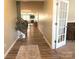 Inviting hallway with wood-look flooring leading to the living spaces and featuring a staircase at 10417 Bluejack Oak Ct, Huntersville, NC 28078