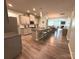 Open kitchen with granite counters, stainless appliances, and a large island with seating for three at 10417 Bluejack Oak Ct, Huntersville, NC 28078