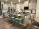 Modern kitchen with stainless steel appliances, granite counters, and an island with seating at 10417 Bluejack Oak Ct, Huntersville, NC 28078