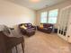 Cozy living room featuring comfortable leather furniture, neutral colors, and plenty of natural light at 10417 Bluejack Oak Ct, Huntersville, NC 28078