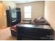 Upstairs living room featuring a large TV, built-in shelving, and comfortable seating at 10417 Bluejack Oak Ct, Huntersville, NC 28078
