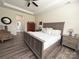Serene main bedroom with a tray ceiling, wood floors, and neutral decor, offering a relaxing retreat at 10417 Bluejack Oak Ct, Huntersville, NC 28078