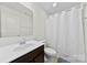 Clean bathroom featuring a modern sink, vanity, and shower with a white curtain, creating a functional and bright space at 1101 Plaza Walk Dr, Charlotte, NC 28215
