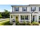 Charming front porch with a yellow door and a welcoming wreath, enhancing the curb appeal of this lovely townhome at 1101 Plaza Walk Dr, Charlotte, NC 28215