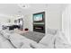 Bright living room featuring a modern fireplace, mounted television, and comfortable sectional sofa, creating an inviting space at 1101 Plaza Walk Dr, Charlotte, NC 28215