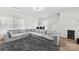 Spacious living room featuring an oversized sectional sofa, large windows, and a cozy carpet, perfect for relaxation at 1101 Plaza Walk Dr, Charlotte, NC 28215