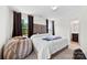 Serene main bedroom with ample natural light, a plush headboard, neutral tones, and access to a private ensuite bathroom at 1101 Plaza Walk Dr, Charlotte, NC 28215