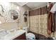 Cozy bathroom with a decorative mirror, shower with curtain, and functional vanity at 11069 Running Ridge Rd, Charlotte, NC 28226