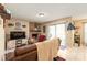 Cozy living room featuring a brick fireplace, tile floors, and sliding glass doors to the outside at 11069 Running Ridge Rd, Charlotte, NC 28226