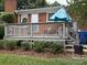 Private deck space for outdoor seating surrounded by mature landscaping and green lawn at 1116 Fieldstone Rd, Mooresville, NC 28115