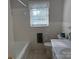 Bathroom with tub, vanity, and neutral tiles offer practicality and comfort at 1116 Fieldstone Rd, Mooresville, NC 28115