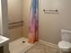 Walk-in shower with accessibility handrails and tile flooring for easy maintenance at 1116 Fieldstone Rd, Mooresville, NC 28115