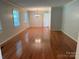 Spacious living room showcases gleaming hardwood floors and ample natural light at 1116 Fieldstone Rd, Mooresville, NC 28115