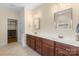 Bathroom with double sink vanity, wood cabinets, walk-in closet and tile flooring at 1119 Williamstown Rd, Matthews, NC 28105