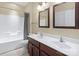 Bathroom featuring double sink vanity, tile flooring, bath tub and shower combination at 1119 Williamstown Rd, Matthews, NC 28105