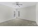 Bedroom with neutral paint and carpet with natural light provided by two windows at 1119 Williamstown Rd, Matthews, NC 28105