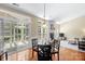 Bright dining area with fireplace, hardwood floors, and sliding glass doors at 1119 Williamstown Rd, Matthews, NC 28105