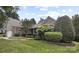 The house features beautiful landscaping at 1119 Williamstown Rd, Matthews, NC 28105