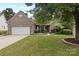 Charming brick home with well-manicured lawn and mature landscaping, creating excellent curb appeal at 1119 Williamstown Rd, Matthews, NC 28105