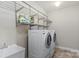 Bright laundry room with shelving and a utility sink with a newer washer and dryer at 1119 Williamstown Rd, Matthews, NC 28105