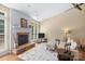 Spacious living room featuring hardwood floors, a fireplace, and a comfortable seating area at 1119 Williamstown Rd, Matthews, NC 28105