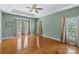 Spacious main bedroom with hardwood floors, a tray ceiling, and natural light at 1119 Williamstown Rd, Matthews, NC 28105