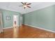 Large main bedroom featuring hardwood floors, neutral walls, and a tray ceiling at 1119 Williamstown Rd, Matthews, NC 28105