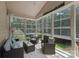 Bright sunroom featuring three comfortable chairs, a sofa, and large windows with natural light at 1119 Williamstown Rd, Matthews, NC 28105