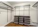 Spacious walk-in closet with custom shelving and storage solutions with wood flooring at 1119 Williamstown Rd, Matthews, NC 28105