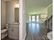 Half bathroom with granite counters, grey cabinets, and wood-look floors at 11533 Valley Oak Ln, Stanfield, NC 28163