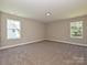 Bright, carpeted bedroom with two windows offering ample natural light at 11533 Valley Oak Ln, Stanfield, NC 28163
