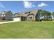 Landscaped home exterior with a well-maintained lawn and traditional architecture at 11533 Valley Oak Ln, Stanfield, NC 28163