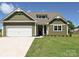 Charming home showcasing a two-car garage and inviting front entryway at 11533 Valley Oak Ln, Stanfield, NC 28163