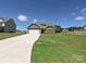 Beautiful home exterior with a well-maintained lawn and a long driveway at 11533 Valley Oak Ln, Stanfield, NC 28163