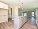 Open-concept kitchen with granite island flows into a living space with plenty of natural light at 11533 Valley Oak Ln, Stanfield, NC 28163