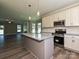 Modern kitchen with stainless steel appliances, granite counters, and eat-in kitchen island at 11533 Valley Oak Ln, Stanfield, NC 28163