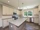 Modern kitchen featuring stainless steel appliances, an island, and pendant lighting at 11533 Valley Oak Ln, Stanfield, NC 28163
