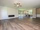Open-concept living room and kitchen with lots of natural light and wood flooring at 11533 Valley Oak Ln, Stanfield, NC 28163