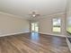 Bright living room featuring wood floors, a ceiling fan, and sliding glass doors at 11533 Valley Oak Ln, Stanfield, NC 28163