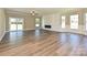 Spacious living room with wood floors, large windows and a modern fireplace at 11533 Valley Oak Ln, Stanfield, NC 28163