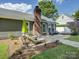 Inviting backyard featuring outdoor seating, a green umbrella and lush green grass and landscaping at 116 Hallett St, Fort Mill, SC 29715